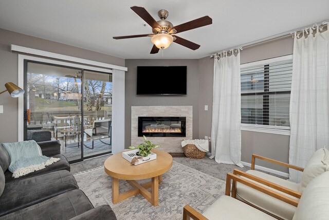 carpeted living room featuring ceiling fan