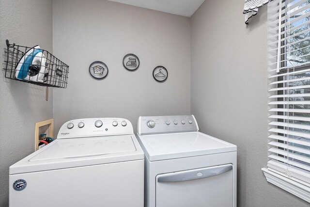 laundry room with washing machine and clothes dryer