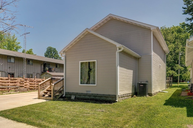 view of property exterior featuring central air condition unit and a lawn