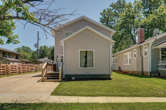 rear view of house with a lawn