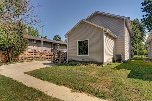 view of home's exterior with a yard, cooling unit, and a deck