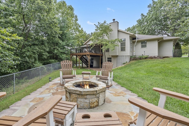 view of patio / terrace with a wooden deck and an outdoor fire pit