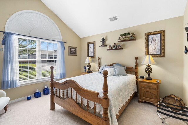 bedroom featuring light carpet and vaulted ceiling