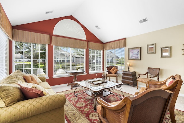 living room with high vaulted ceiling, a wealth of natural light, and carpet flooring