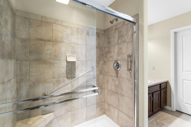 bathroom with vanity and a shower with door