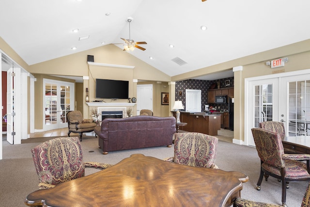 carpeted dining space featuring lofted ceiling, ceiling fan, and french doors