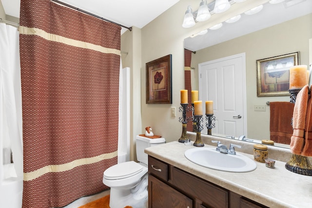 bathroom featuring vanity, toilet, and curtained shower