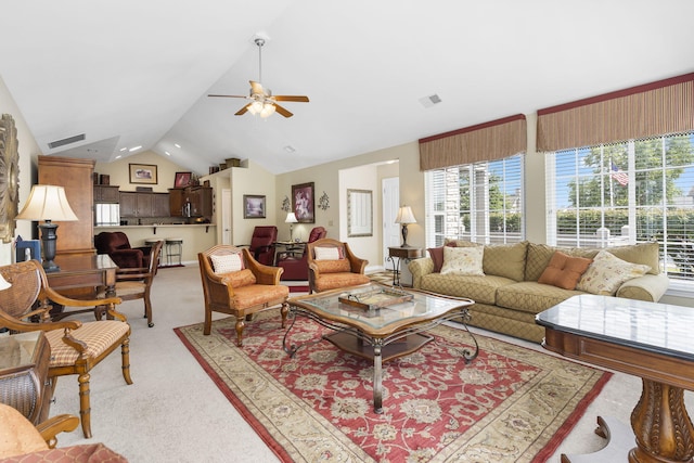 living room featuring ceiling fan, light colored carpet, and lofted ceiling