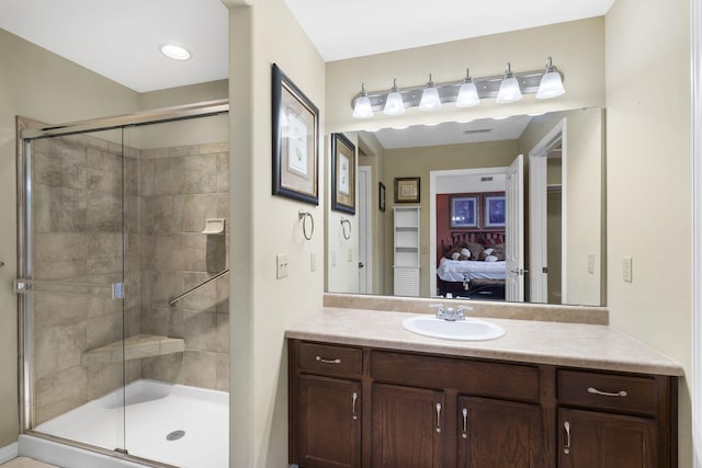 bathroom featuring walk in shower and vanity