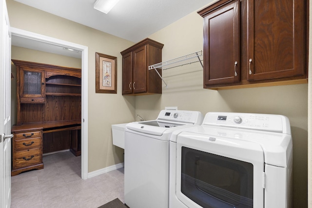 laundry area with washing machine and dryer and cabinets