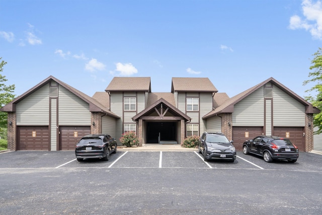 view of front of home with brick siding and uncovered parking