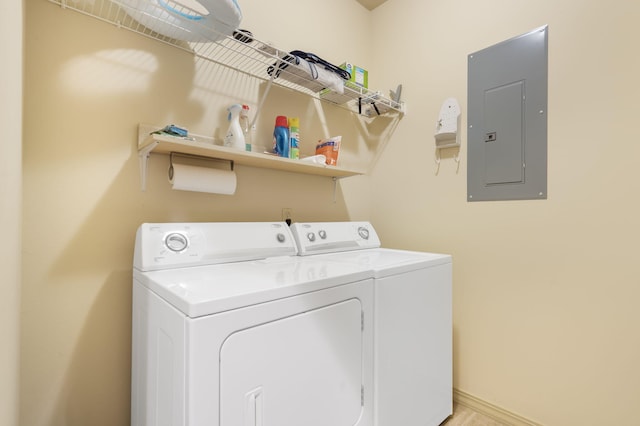 laundry room featuring electric panel and washer and dryer