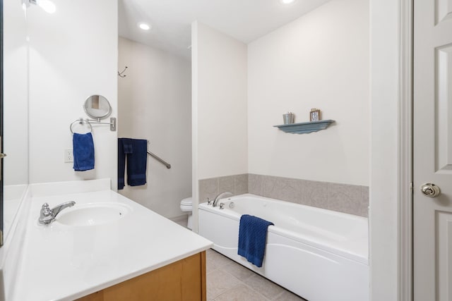 bathroom with a tub to relax in, toilet, tile patterned flooring, and vanity