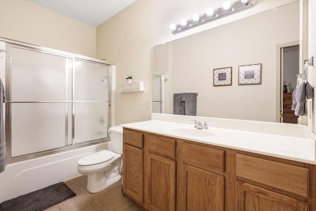 full bath featuring vanity, toilet, tile patterned flooring, and shower / bath combination with glass door