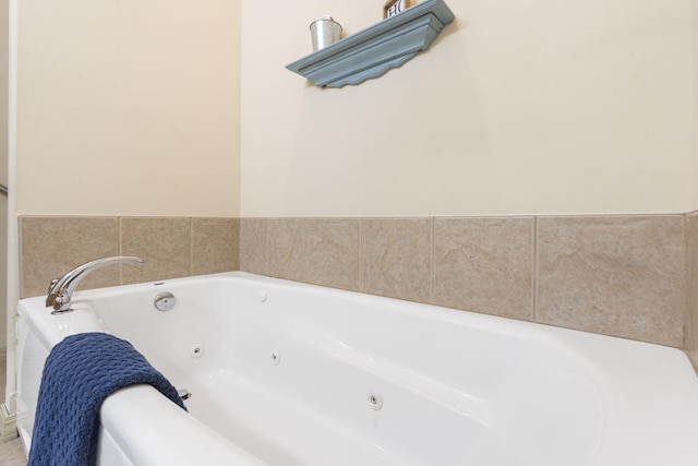 bathroom featuring a tub with jets