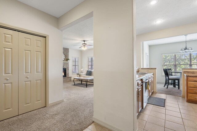 corridor with light carpet, a sink, recessed lighting, and plenty of natural light