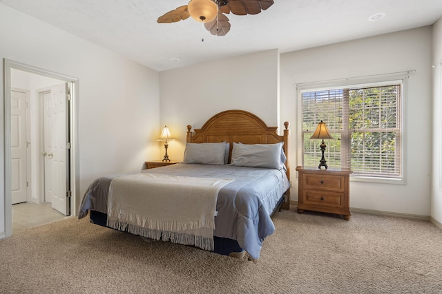 carpeted bedroom featuring ceiling fan