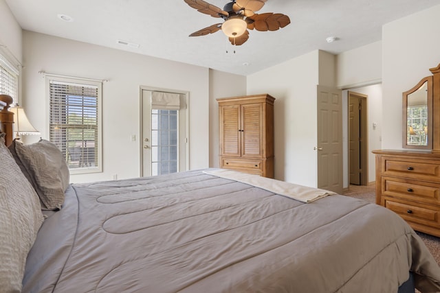 bedroom with ceiling fan, visible vents, and light carpet