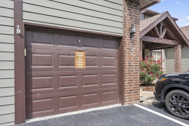 property entrance featuring driveway and a garage