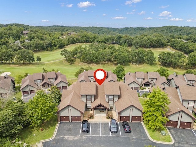 drone / aerial view featuring a forest view and golf course view