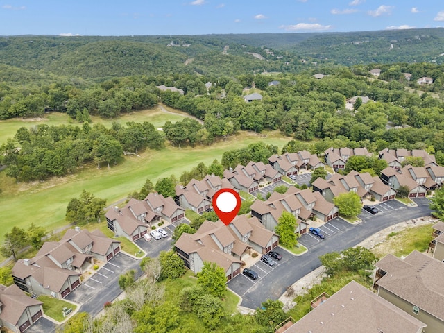 drone / aerial view featuring golf course view and a residential view