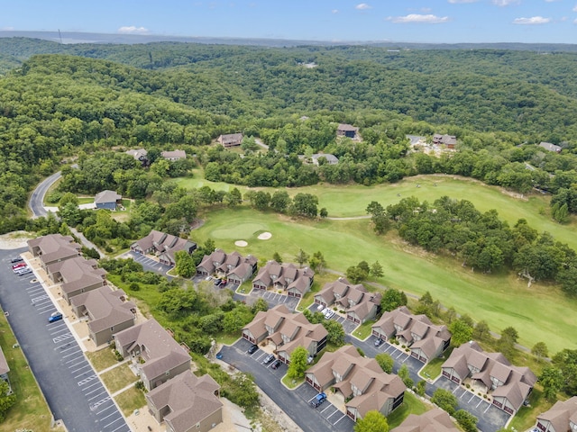 birds eye view of property with a forest view, a residential view, and golf course view