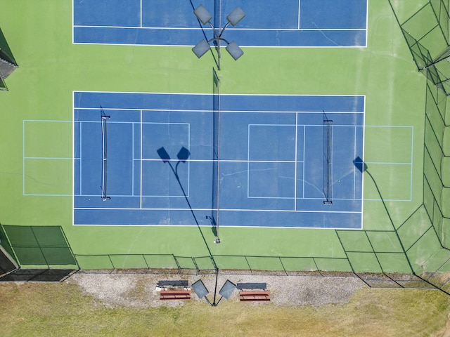 view of tennis court featuring fence