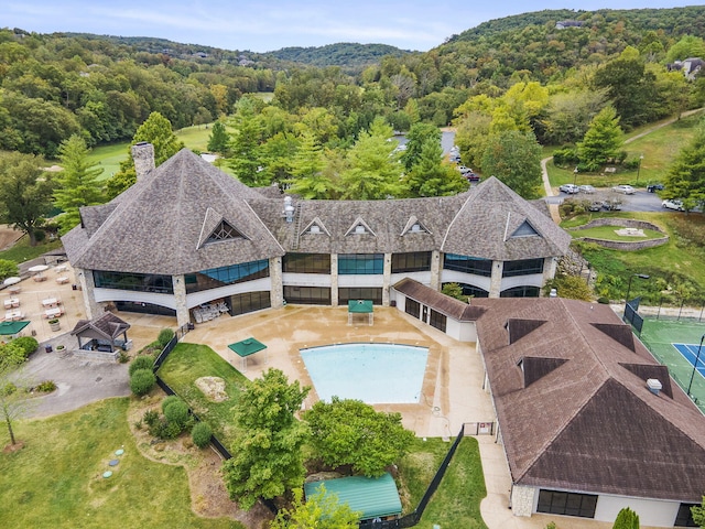 birds eye view of property featuring a view of trees