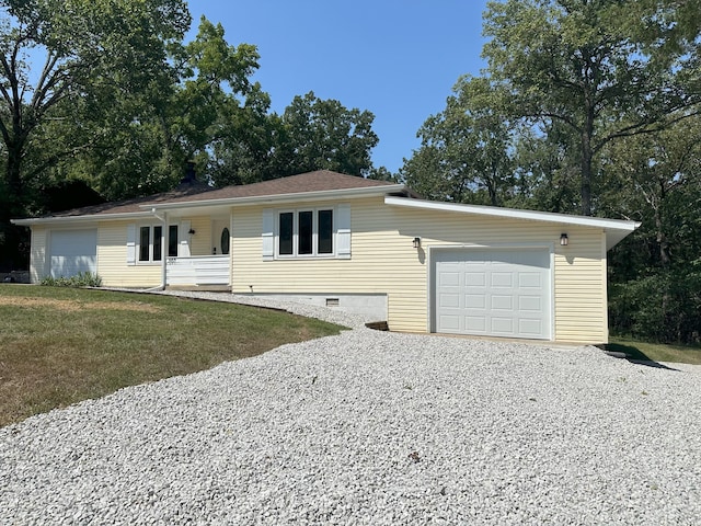 single story home featuring a front yard and a garage