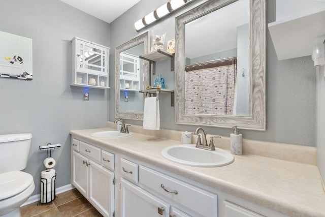 bathroom featuring tile patterned flooring, vanity, and toilet