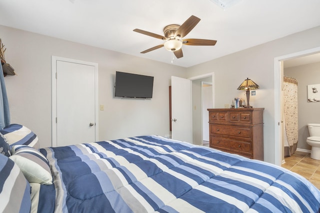 bedroom with light tile patterned floors, a closet, ensuite bathroom, and ceiling fan