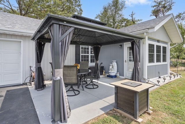 view of patio / terrace with a gazebo and a garage