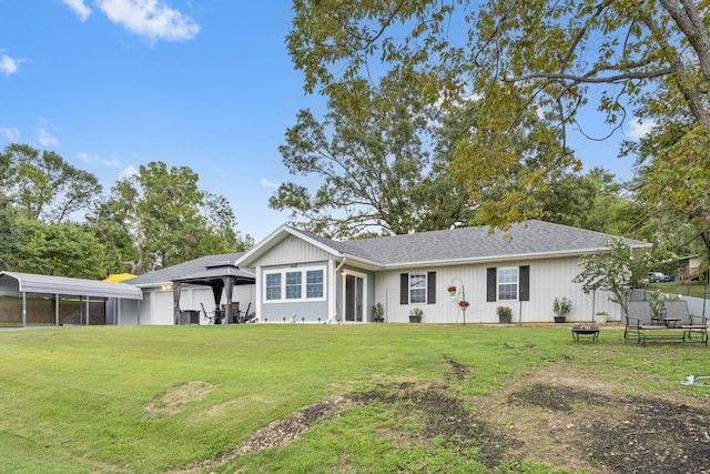 view of front of property with a carport, a front lawn, and a gazebo