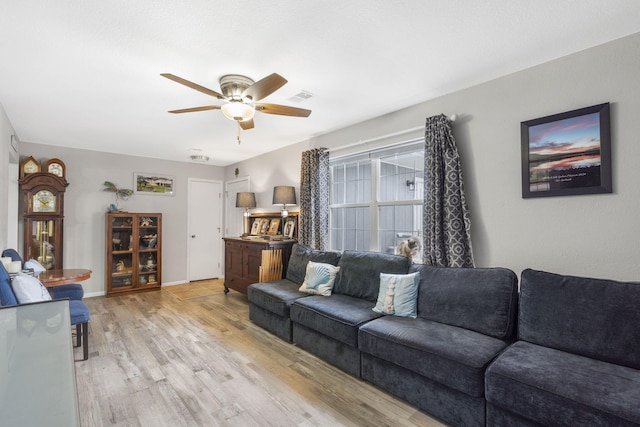 living room featuring ceiling fan and light hardwood / wood-style floors