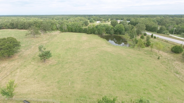 birds eye view of property with a water view and a rural view