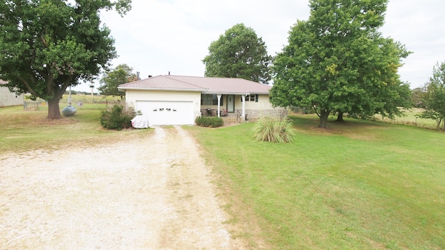 single story home with a front yard and a garage