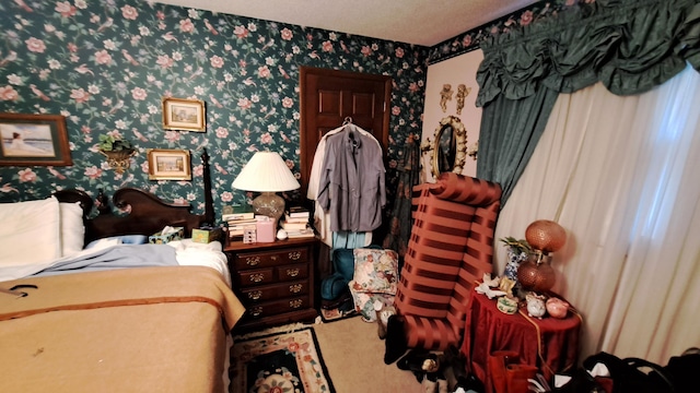 bedroom with wallpapered walls and carpet floors
