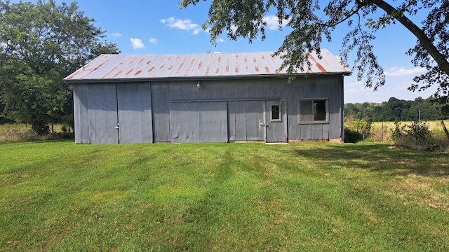 view of outbuilding with a yard