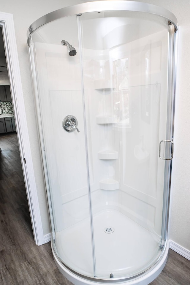 bathroom featuring hardwood / wood-style floors and an enclosed shower