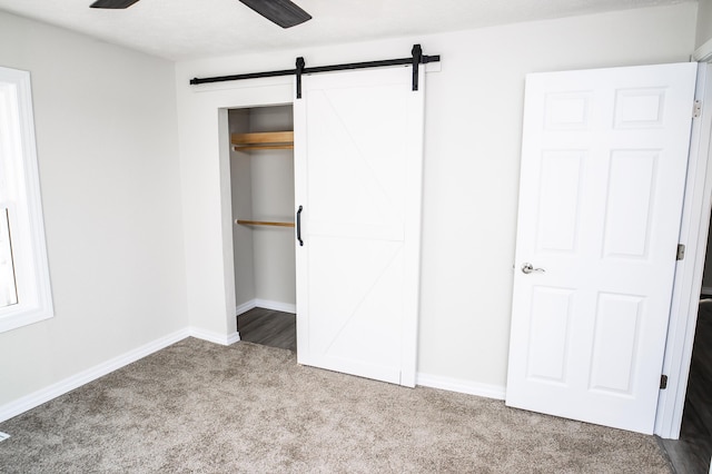 500 E Lincoln St, Buffalo, MO 65622 - unfurnished bedroom featuring a barn door, baseboards, carpet flooring, and a closet