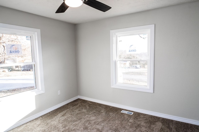 carpeted spare room with ceiling fan