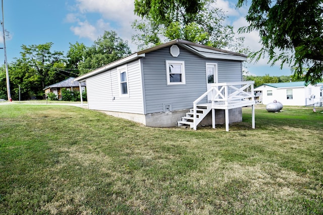 rear view of house featuring a yard