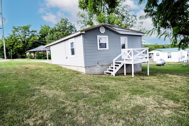 500 E Lincoln St, Buffalo, MO 65622 - rear view of property featuring a lawn and a deck