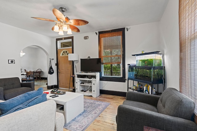 living room with ceiling fan and light hardwood / wood-style flooring