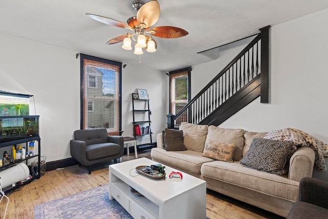 living room featuring ceiling fan and light hardwood / wood-style flooring