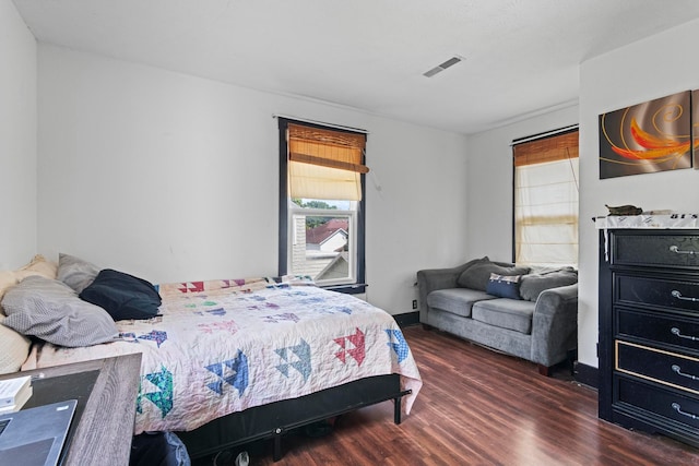 bedroom with dark wood-type flooring