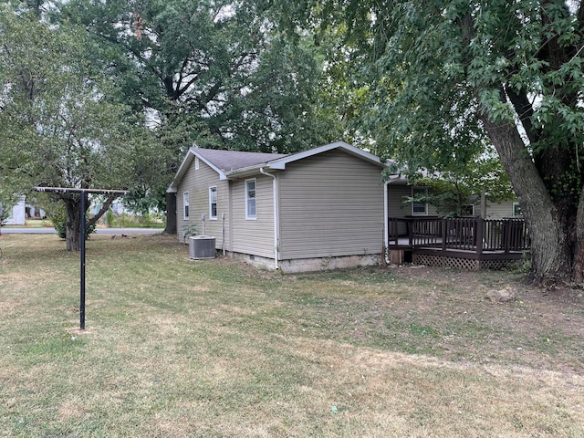 view of property exterior featuring a yard, central AC, and a deck