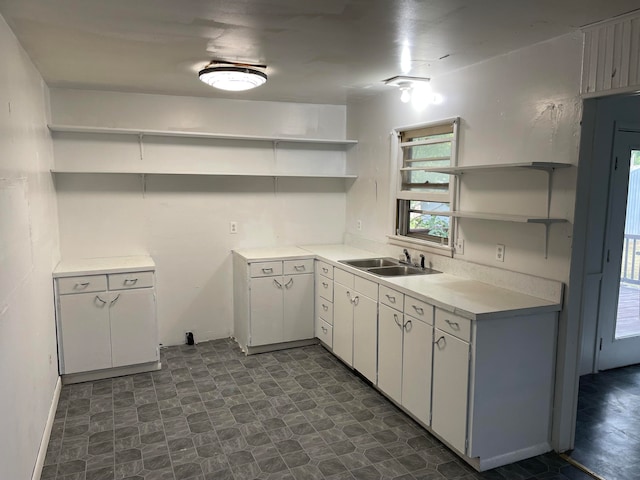 kitchen featuring white cabinets and sink