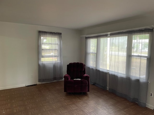 sitting room featuring dark parquet floors