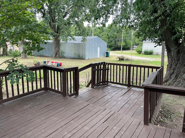 wooden deck featuring a yard and an outdoor structure